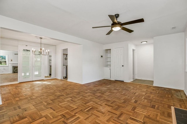 4428 N Monroe Ave, Kansas City, MO 64117 - unfurnished room with ceiling fan and a chandelier