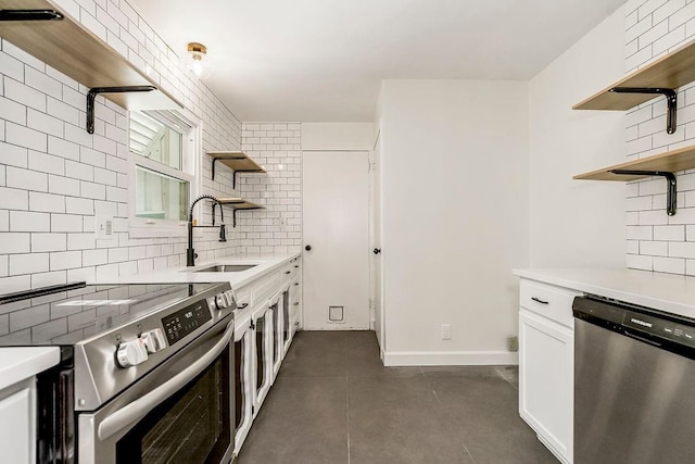4428 N Monroe Ave, Kansas City, MO 64117 - kitchen with open shelves, appliances with stainless steel finishes, decorative backsplash, and light countertops