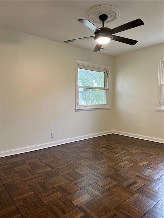 4428 N Monroe Ave, Kansas City, MO 64117 - spare room with a ceiling fan and baseboards