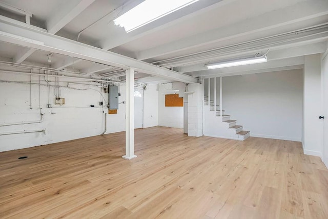 4428 N Monroe Ave, Kansas City, MO 64117 - finished below grade area with stairway, electric panel, and wood finished floors
