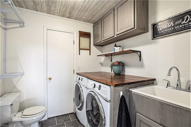 21318 S Briar Rd, Peculiar, MO 64078 - laundry room with washer and clothes dryer, dark tile patterned floors, and crown molding