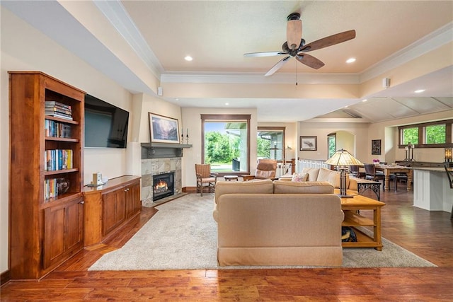 26793 W 100th Pl, Olathe, KS 66061 - living area with ornamental molding, a fireplace, wood finished floors, ceiling fan, and recessed lighting