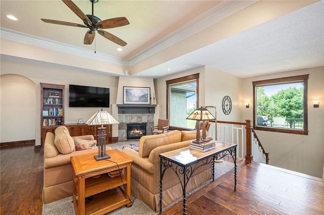 26793 W 100th Pl, Olathe, KS 66061 - living area with hardwood / wood-style flooring, healthy amount of natural light, crown molding, a stone fireplace, and a ceiling fan
