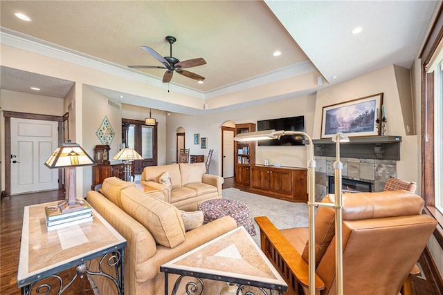 26793 W 100th Pl, Olathe, KS 66061 - living room featuring arched walkways, crown molding, ceiling fan, a stone fireplace, and recessed lighting