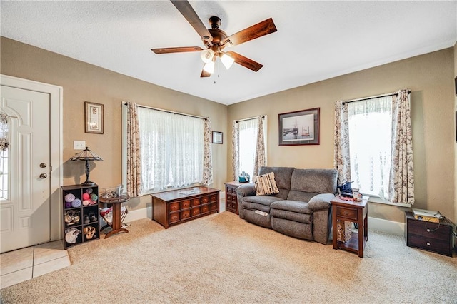 1002 S Olive St, Holden, MO 64040 - carpeted living area featuring a ceiling fan and baseboards