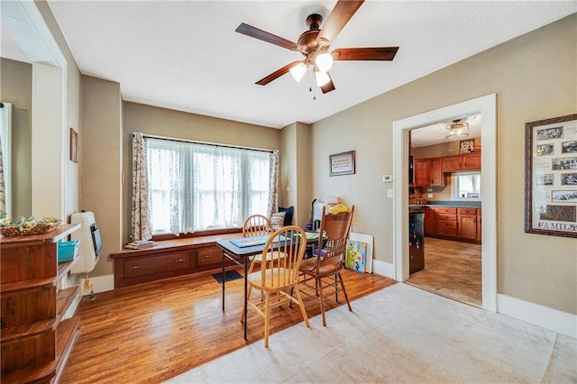1002 S Olive St, Holden, MO 64040 - dining room featuring a ceiling fan, heating unit, and light wood-type flooring