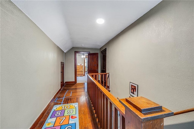 1002 S Olive St, Holden, MO 64040 - hallway with hardwood / wood-style floors, an upstairs landing, lofted ceiling, a textured wall, and recessed lighting