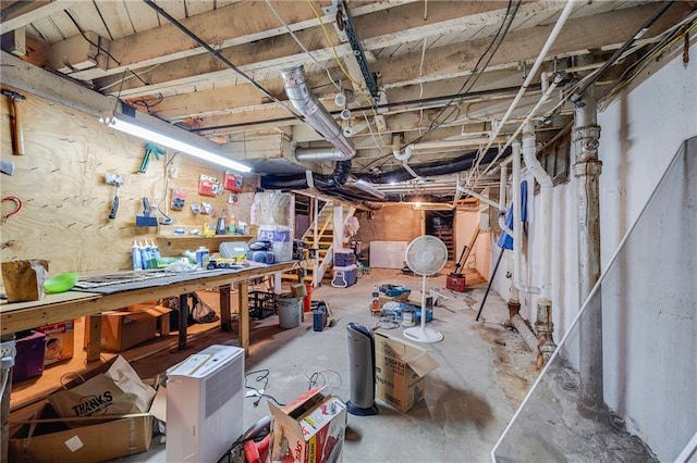 1002 S Olive St, Holden, MO 64040 - unfinished below grade area with a workshop area