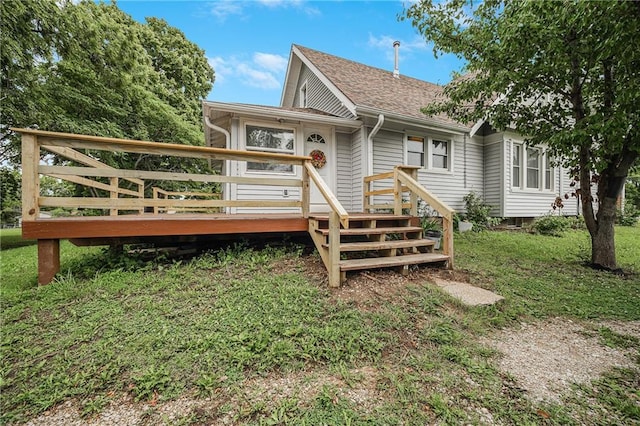 1002 S Olive St, Holden, MO 64040 - back of property with a wooden deck, a lawn, and a shingled roof