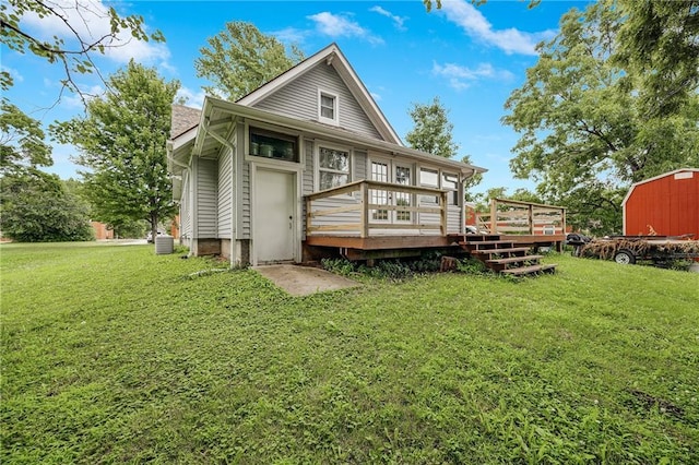 1002 S Olive St, Holden, MO 64040 - back of property with a deck, a storage shed, and a lawn