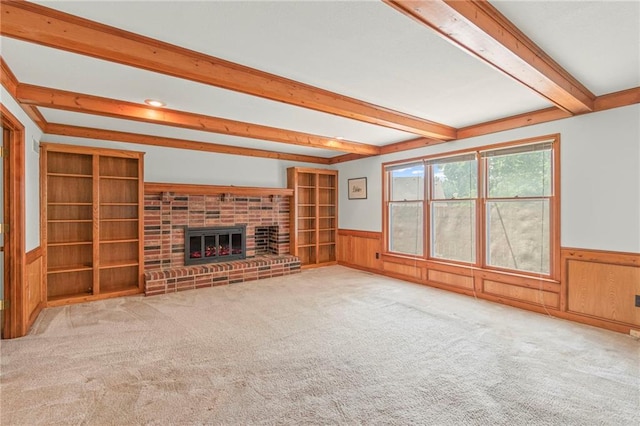 320 SW Raven Ct, Lees Summit, MO 64081 - unfurnished living room with wainscoting, beam ceiling, carpet floors, and a fireplace