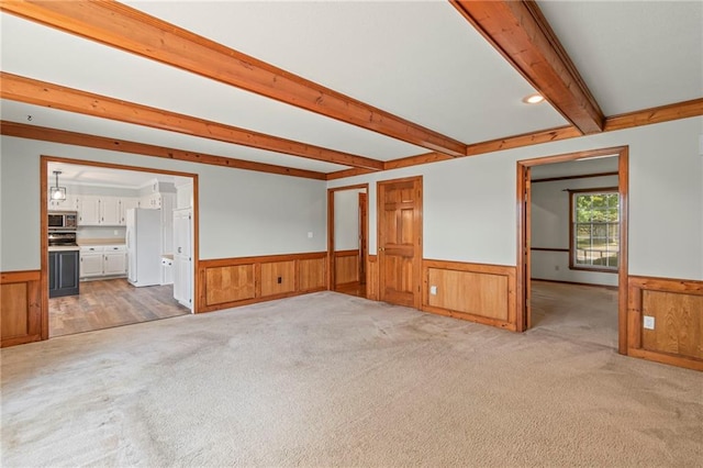 320 SW Raven Ct, Lees Summit, MO 64081 - empty room with wainscoting, beamed ceiling, light colored carpet, and wooden walls