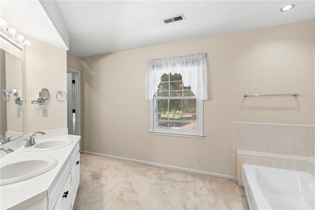 320 SW Raven Ct, Lees Summit, MO 64081 - bathroom featuring double vanity, a bath, and recessed lighting
