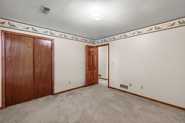 320 SW Raven Ct, Lees Summit, MO 64081 - unfurnished bedroom with carpet, a textured ceiling, and a closet