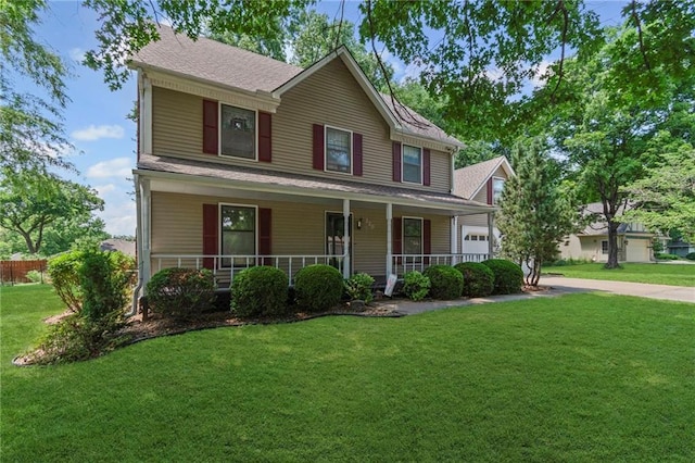 320 SW Raven Ct, Lees Summit, MO 64081 - view of front of house featuring a front yard, a garage, covered porch, roof with shingles, and driveway