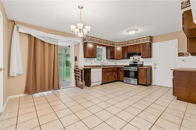 602 N Westview Dr, Richmond, MO 64085 - kitchen with stainless steel gas range, dishwasher, a chandelier, pendant lighting, and under cabinet range hood
