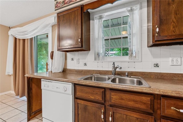 602 N Westview Dr, Richmond, MO 64085 - kitchen featuring dishwasher, light tile patterned flooring, and backsplash