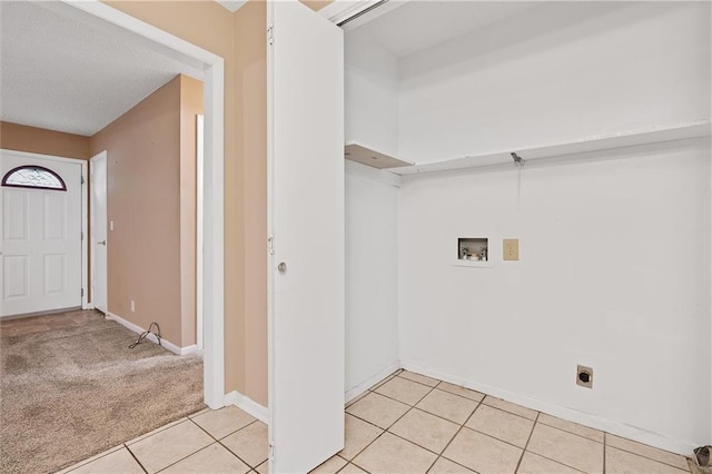 602 N Westview Dr, Richmond, MO 64085 - laundry room with electric dryer hookup, washer hookup, light tile patterned floors, and light colored carpet
