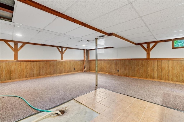 602 N Westview Dr, Richmond, MO 64085 - basement with wooden walls, a paneled ceiling, a wainscoted wall, and carpet