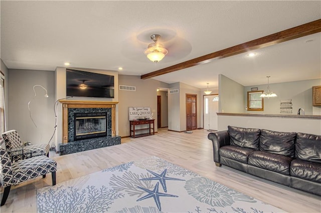 106 Timber Valley Dr, Linn Valley, KS 66040 - living room featuring wood finished floors, a fireplace, a ceiling fan, a chandelier, and recessed lighting