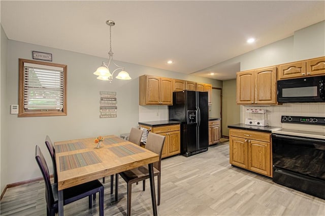 106 Timber Valley Dr, Linn Valley, KS 66040 - kitchen featuring black appliances, tasteful backsplash, a chandelier, dark countertops, and hanging light fixtures