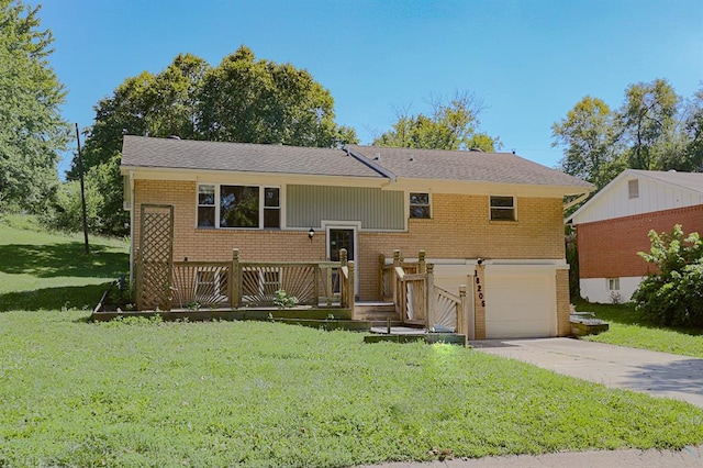 18205 E 27th St S, Independence, MO 64057 - bi-level home with brick siding, an attached garage, a front lawn, and concrete driveway