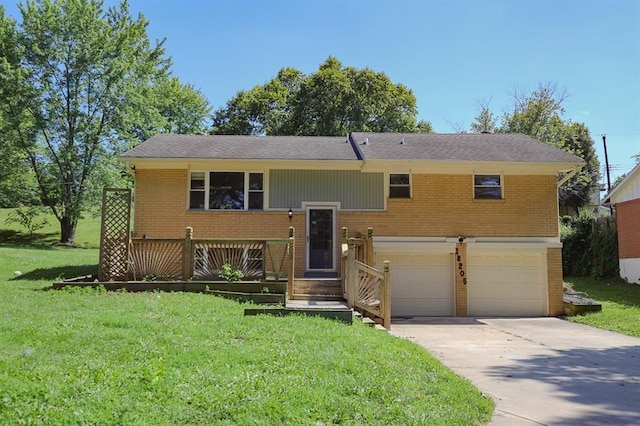 18205 E 27th St S, Independence, MO 64057 - bi-level home with brick siding, a garage, a front lawn, and concrete driveway