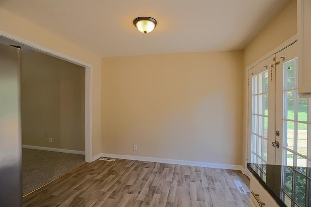 18205 E 27th St S, Independence, MO 64057 - unfurnished room featuring plenty of natural light, wood finished floors, and french doors