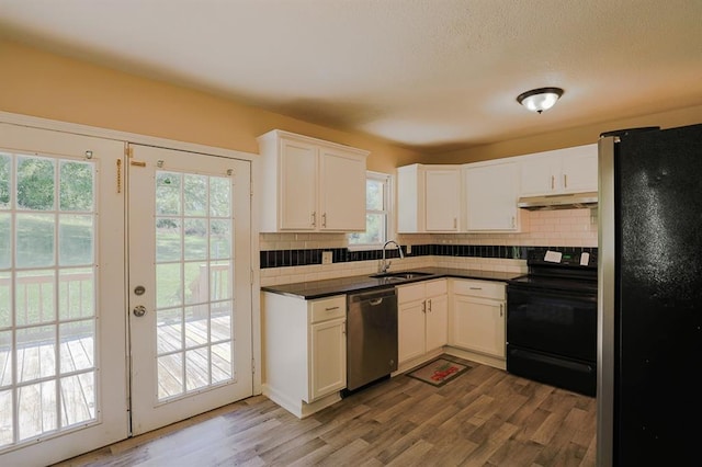 18205 E 27th St S, Independence, MO 64057 - kitchen featuring appliances with stainless steel finishes, under cabinet range hood, decorative backsplash, and dark countertops