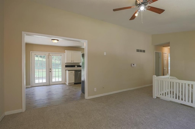 18205 E 27th St S, Independence, MO 64057 - empty room featuring light carpet, a ceiling fan, and french doors