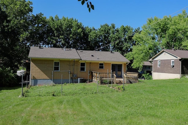 18205 E 27th St S, Independence, MO 64057 - back of property featuring a deck, a yard, and brick siding