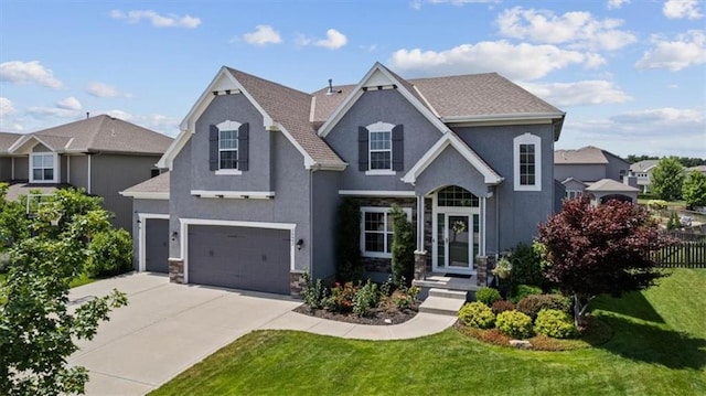16642 W 165th St, Olathe, KS 66062 - view of front facade featuring stucco siding, driveway, stone siding, and a garage