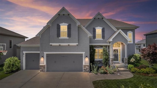 16642 W 165th St, Olathe, KS 66062 - view of front of property with stone siding, driveway, stucco siding, and a garage
