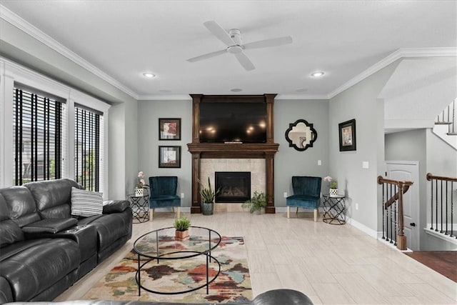 16642 W 165th St, Olathe, KS 66062 - living room featuring a ceiling fan, a tiled fireplace, crown molding, recessed lighting, and stairway