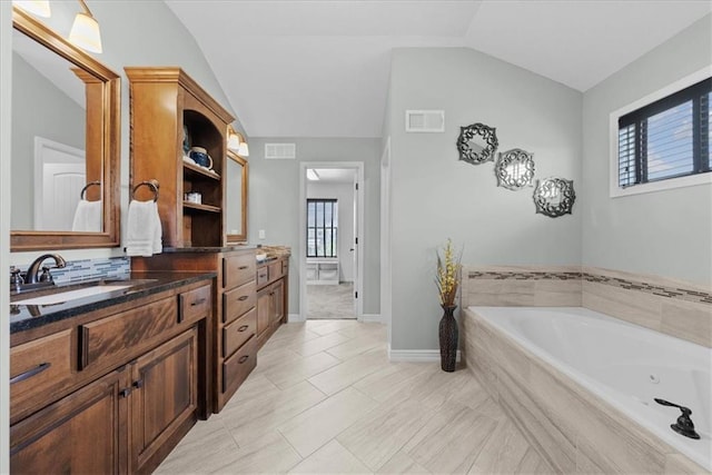 16642 W 165th St, Olathe, KS 66062 - bathroom with vanity, a jetted tub, and vaulted ceiling