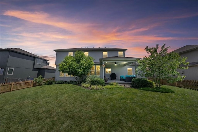 16642 W 165th St, Olathe, KS 66062 - back of property at dusk featuring ceiling fan, a patio, and a fenced backyard