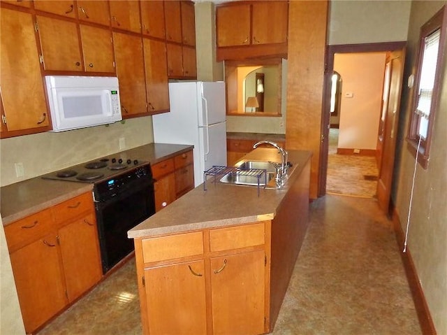 1915 S Elm St, Pittsburg, KS 66762 - kitchen with white appliances, light flooring, and brown cabinets