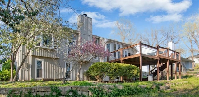 9305 NW 80th St, Weatherby Lake, MO 64152 - back of property featuring a wooden deck, a chimney, and stairs