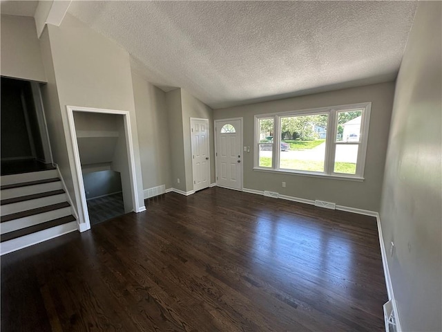 806 Lea Dr, Lees Summit, MO 64081 - foyer entrance with lofted ceiling, dark wood-style floors, a textured ceiling, and stairway