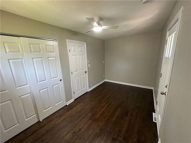 806 Lea Dr, Lees Summit, MO 64081 - unfurnished bedroom featuring dark wood-style flooring, a textured ceiling, and a ceiling fan