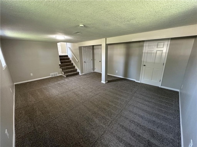 806 Lea Dr, Lees Summit, MO 64081 - finished below grade area with stairway, a textured ceiling, and dark colored carpet