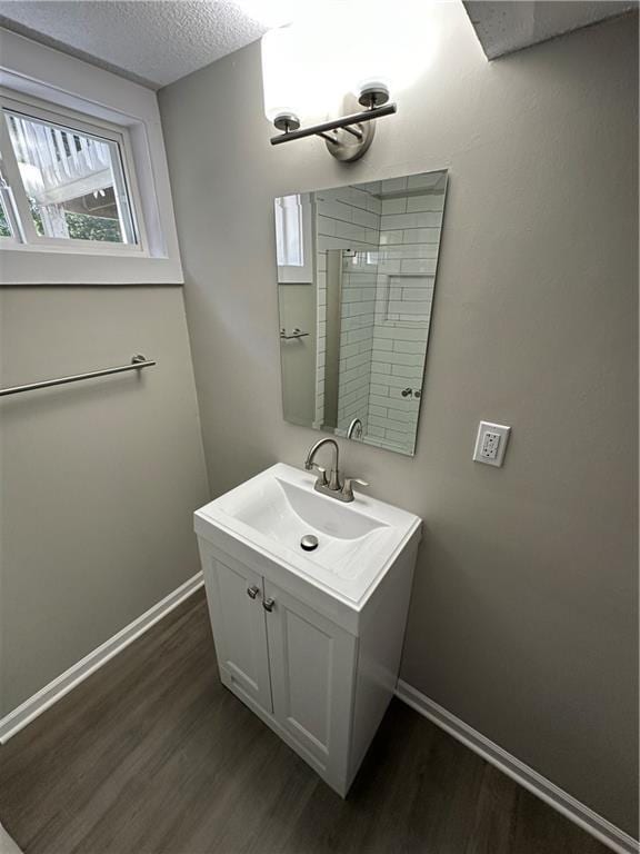 806 Lea Dr, Lees Summit, MO 64081 - bathroom featuring wood finished floors, vanity, and a textured ceiling