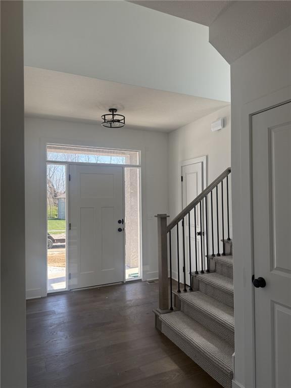 9011 N Colorado Ave, Kansas City, MO 64156 - foyer with dark wood finished floors and stairs