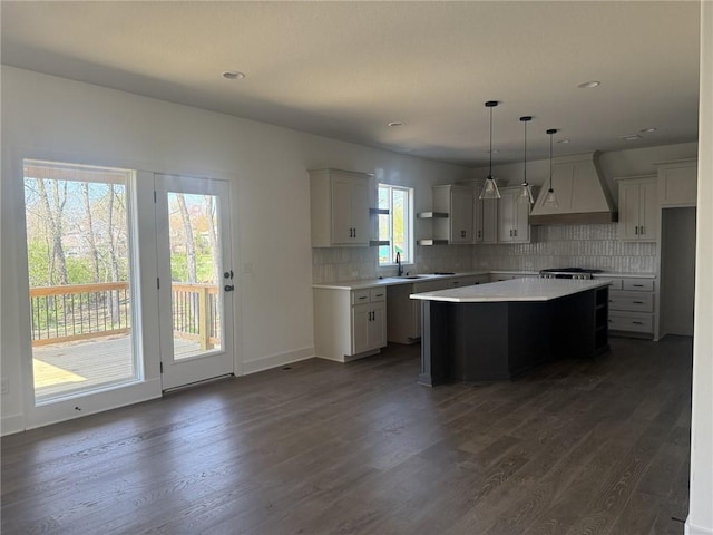 9011 N Colorado Ave, Kansas City, MO 64156 - kitchen with custom range hood, open shelves, dark wood-type flooring, a center island, and tasteful backsplash