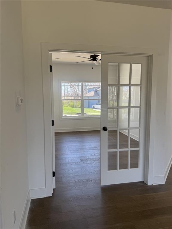 9011 N Colorado Ave, Kansas City, MO 64156 - hall with dark wood-style flooring and baseboards