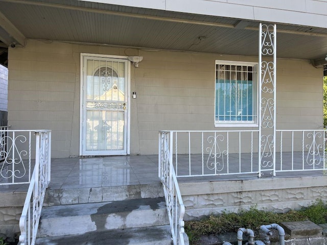 144 N Brighton Ave, Kansas City, MO 64123 - view of exterior entry featuring covered porch