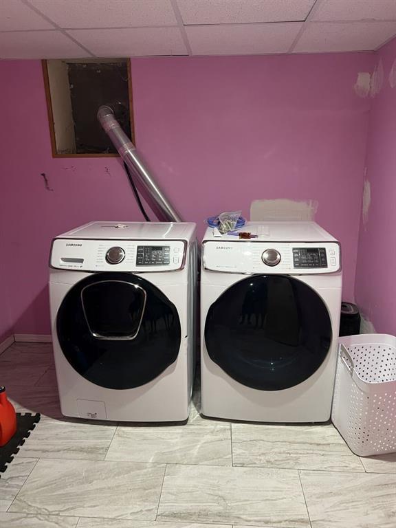144 N Brighton Ave, Kansas City, MO 64123 - laundry room featuring washing machine and dryer and baseboards