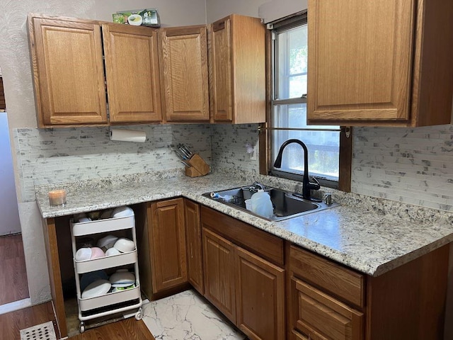 144 N Brighton Ave, Kansas City, MO 64123 - kitchen with tasteful backsplash and brown cabinets