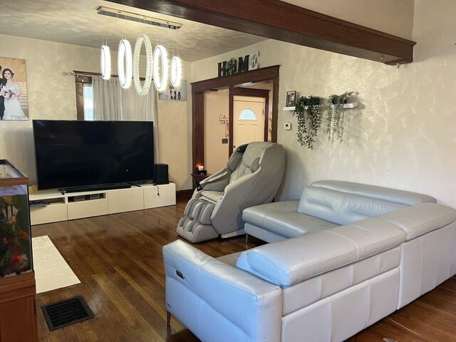 144 N Brighton Ave, Kansas City, MO 64123 - living room featuring wood finished floors and a textured wall