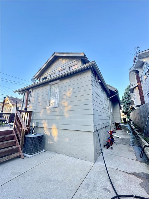144 N Brighton Ave, Kansas City, MO 64123 - view of side of property with a patio area and a wooden deck
